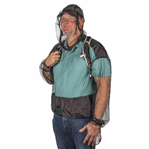A person wearing a bug net jacket on a white background