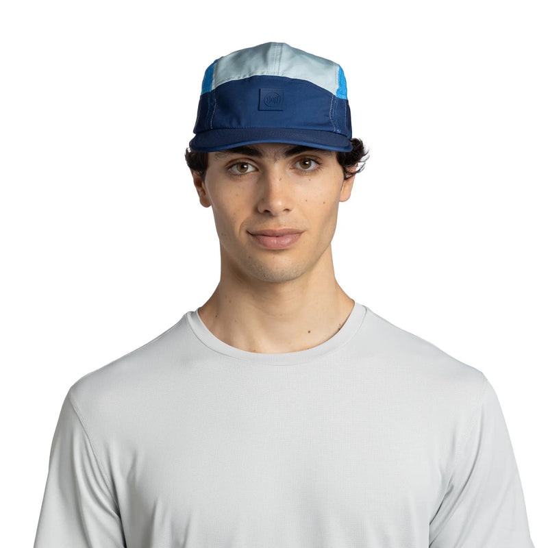 Man wearing a blue and gray cap on a white background