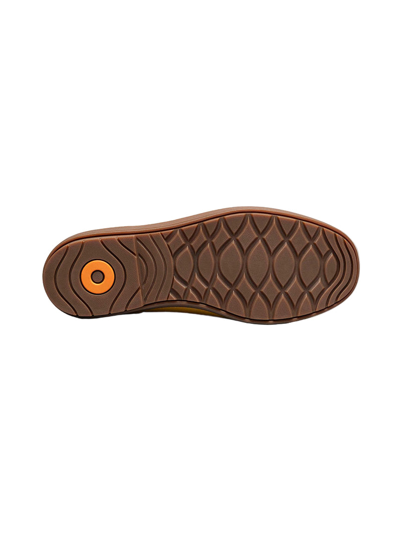 Brown shoe sole with a textured pattern on a white background