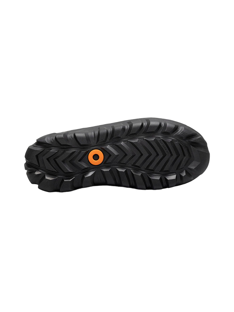 Black sole of a shoe with an orange circular logo on a white background
