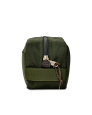 Side view of a dark green travel bag against a white background. 