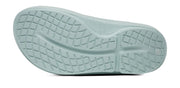 Close-up of a light blue shoe sole with tread pattern on a white background