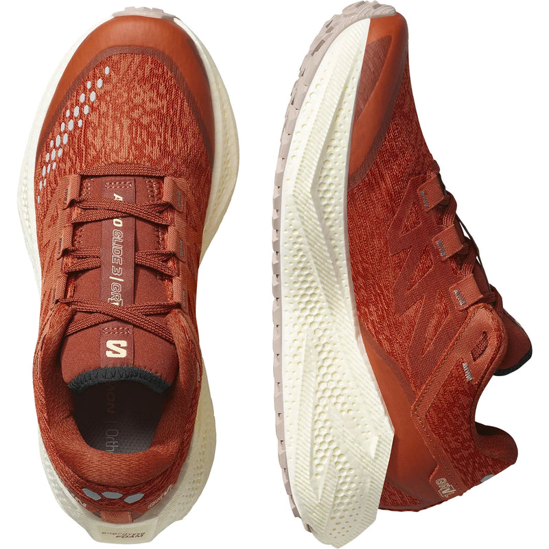 Orange running shoes, shown from above and the side, on a white background