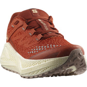 Orange running shoe with dusky purple accents and thick off-white midsoles, photographed at a three-quarters view on a white background