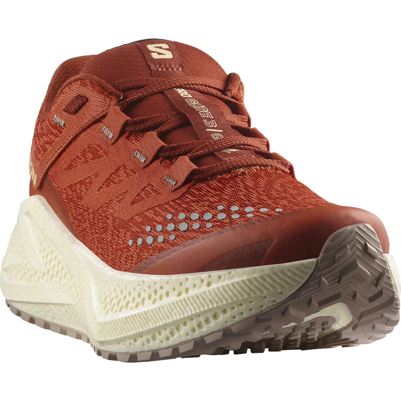 Orange running shoe with dusky purple accents and thick off-white midsoles, photographed at a three-quarters view on a white background