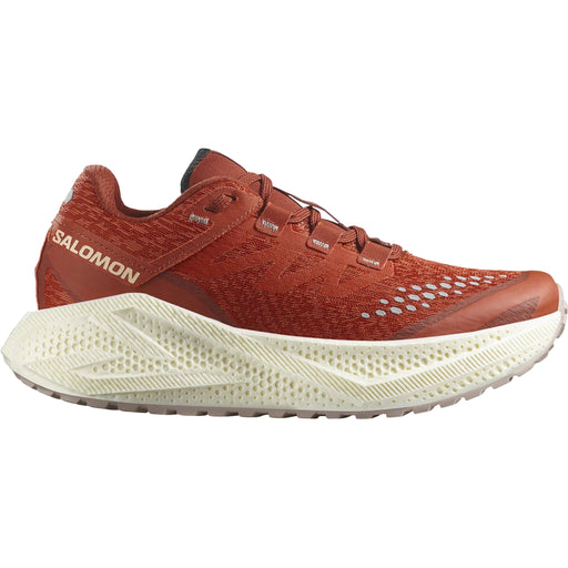 Orange running sneaker with thick outsoles on a white background