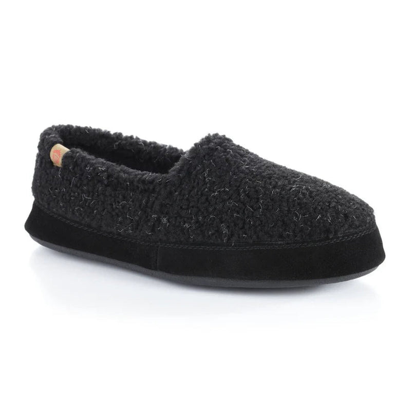 A fuzzy black slipper with a black bottom on a white background