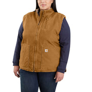 Woman wearing a Carhartt brown colored sherpa lined vest against a white background. The vest has one pocket on the chest , as well as two pouch pockets towards the bottom. 