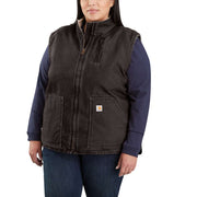 Smiling woman wearing a dark brown colored sherpa-lined vest against a white background. The vest has a zippered pocket on the chest, as well as two pouch pockets towards the bottom. 