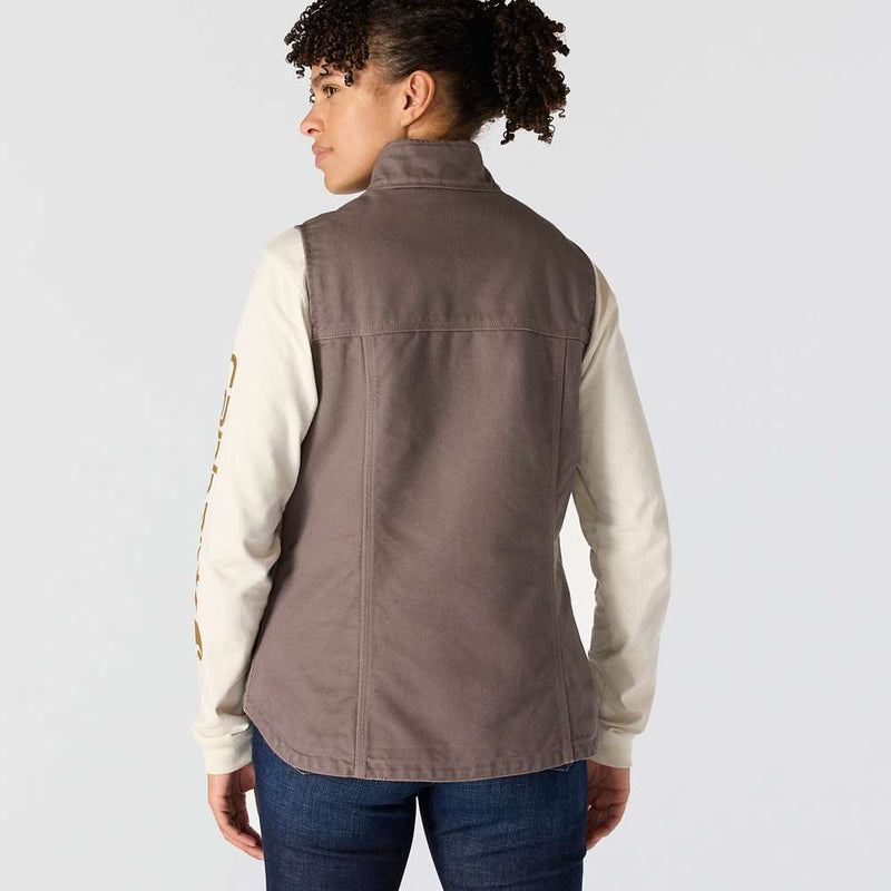 Back view of a woman wearing a taupe colored sherpa lined vest against a white background. 