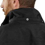 Close-up back view of a man wearing a black jacket, showing the collar, snap button details, and fabric texture against a white background.