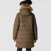 Back view of a woman wearing a tarmac brown colored parka with a fur lined hood against a white background. The parka almost reaches down to her knees. 