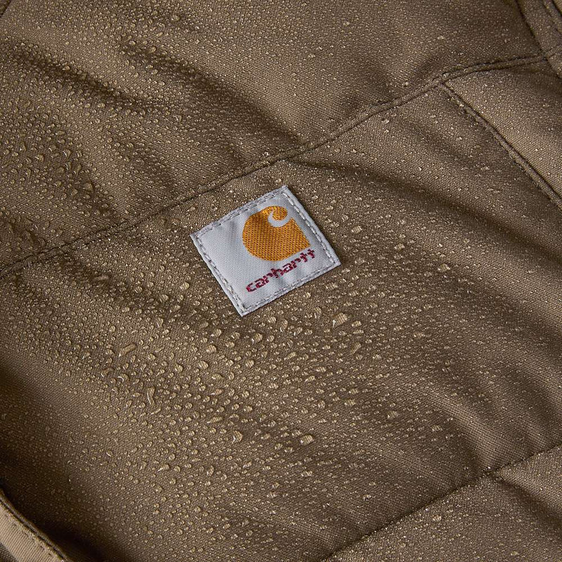 Very close-up image of a tarmac brown parka wicking water with a Carhartt logo in the center.