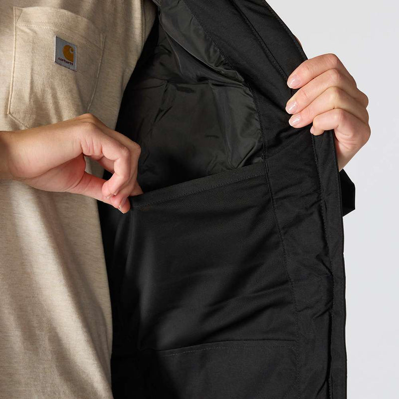 Woman opening black parka to reveal a pocket on the inside against a white background.