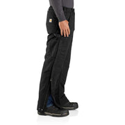 Side view of a man wearing loose fitting black work pants that open up on the sides against a white background. 