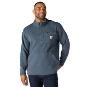 Man wearing a faded navy colored fleece jacket against a white background. the jacket has a chest pocket with a Carhartt logo on it as well as a zippered pouch pocket towards the bottom. 
