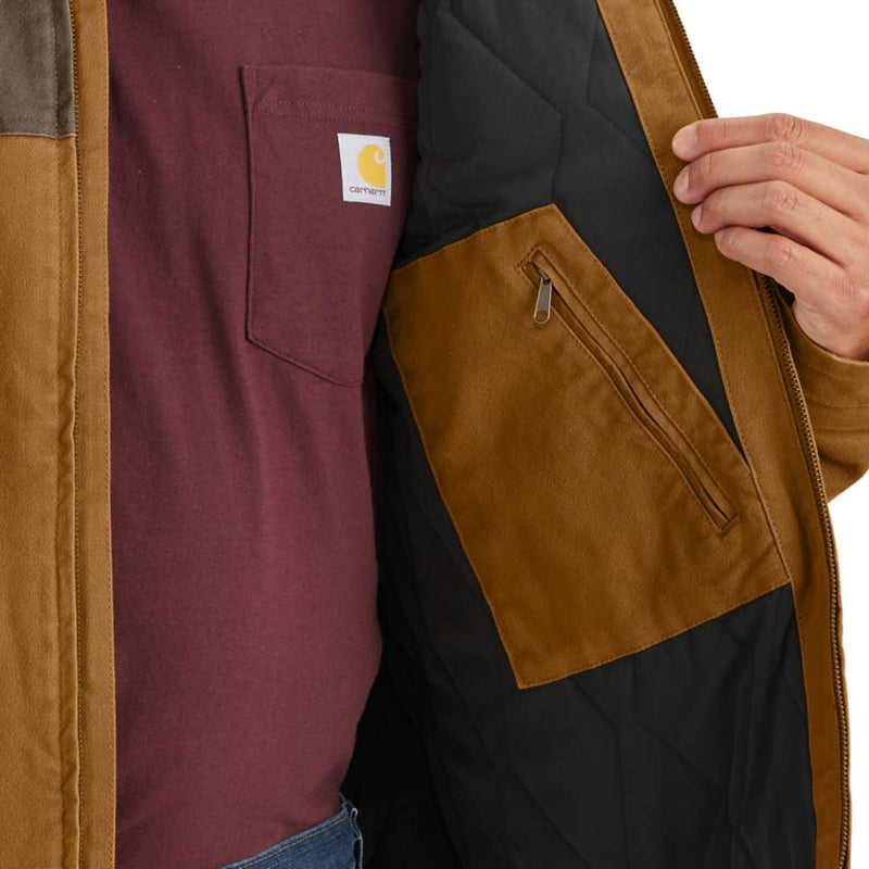 Man opening brown duck-lined insulated jacket to show off a zippered pocket on the inside of the jacket. 