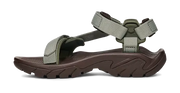 Side view of a dark brown sandal with green straps on a white background.