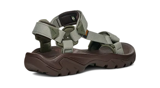 Side view of a dark brown sandal with green straps on a white background.