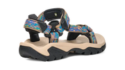 Side view of a tan sandal with colorful straps on a white background.