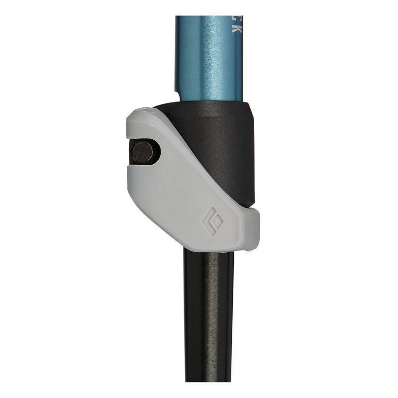 The adjustment system of a blue and black hiking pole on a white background