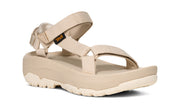 Side view of a beige platform sandal on a white background.