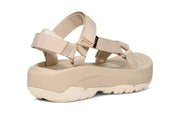 Side view of a beige platform sandal on a white background.