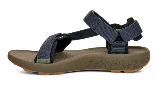 Side view of a dark green sandal with blue straps on a white background.