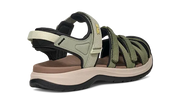 Side view of a green and tan sandal on a white background.