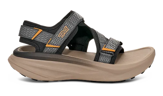 Side view of a tan sandal with grey and black straps on a white background.