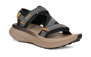 Tan sandal with grey and black straps on a white background.