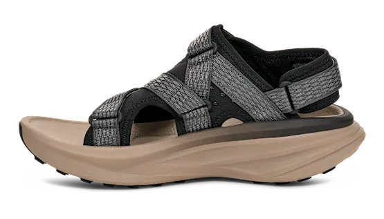 Side view of a tan sandal with grey and black straps on a white background.