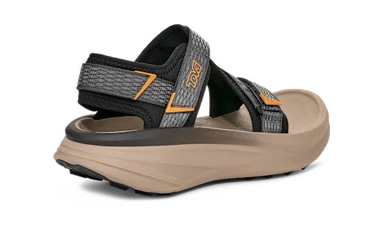 Side view of a tan sandal with grey and black straps on a white background.