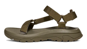 Side view of a dark green sandal on a white background.
