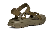 Side view of a dark green sandal on a white background.