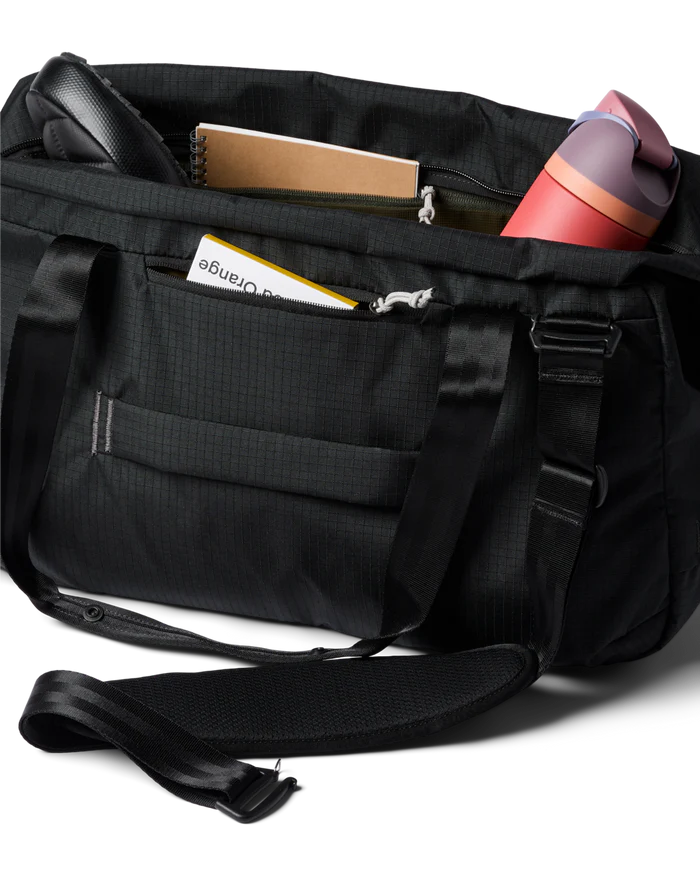 A black duffel bag with gear inside