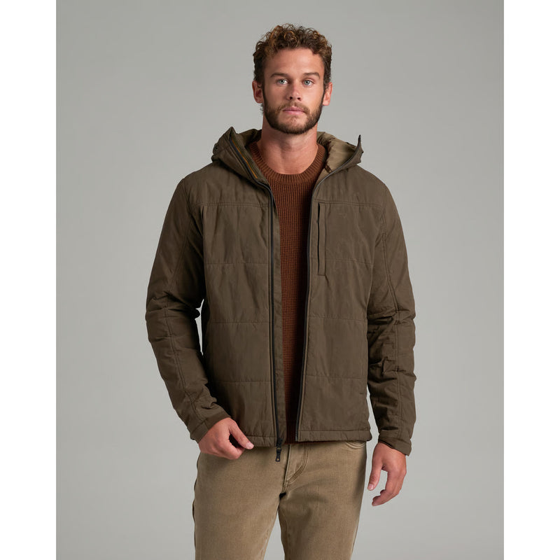 A person wearing a green jacket on a gray background