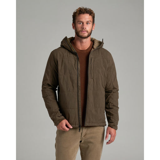 A person wearing a green jacket on a gray background