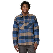 Man wearing a blue and brown plaid shirt with a visible Patagonia brand logo on a white background