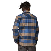 Person wearing a blue and brown plaid shirt on a white background