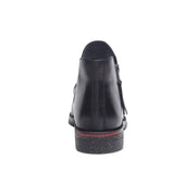 Black shoe with a red sole on a white background