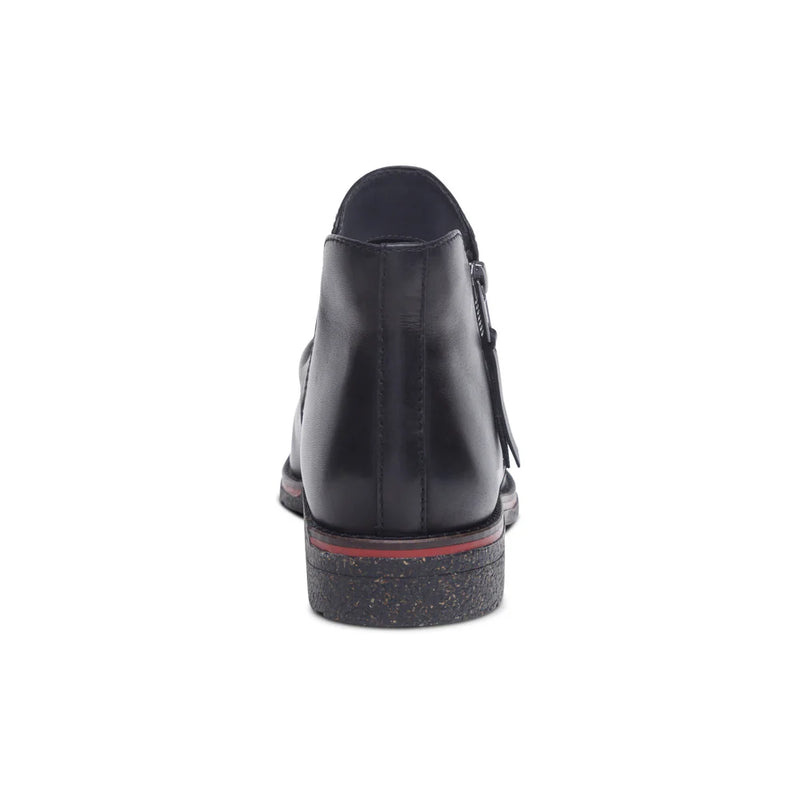 Black shoe with a red sole on a white background