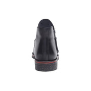Black shoe with a red sole on a white background