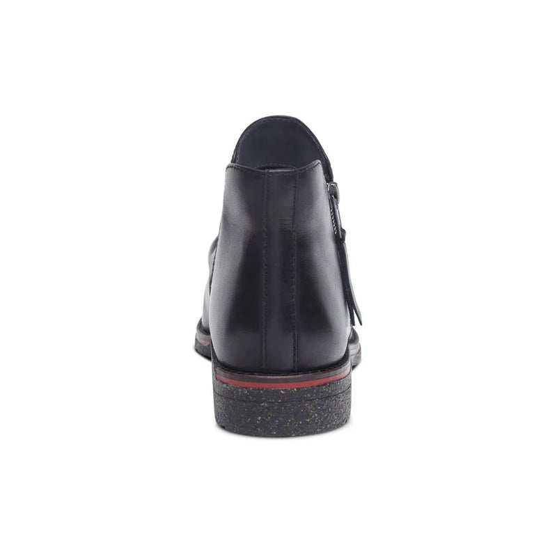 Black shoe with a red sole on a white background
