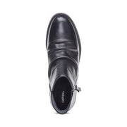 Black ankle boot with 'Aetrex' branding on a white background