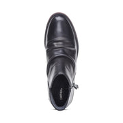 Black ankle boot with 'Aetrex' branding on a white background