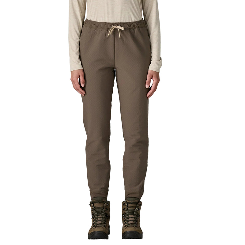 Brown pants worn by a person on a white background