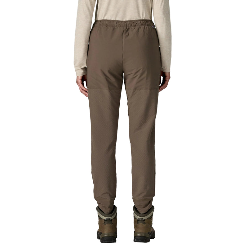 Brown pants worn by a person on a white background