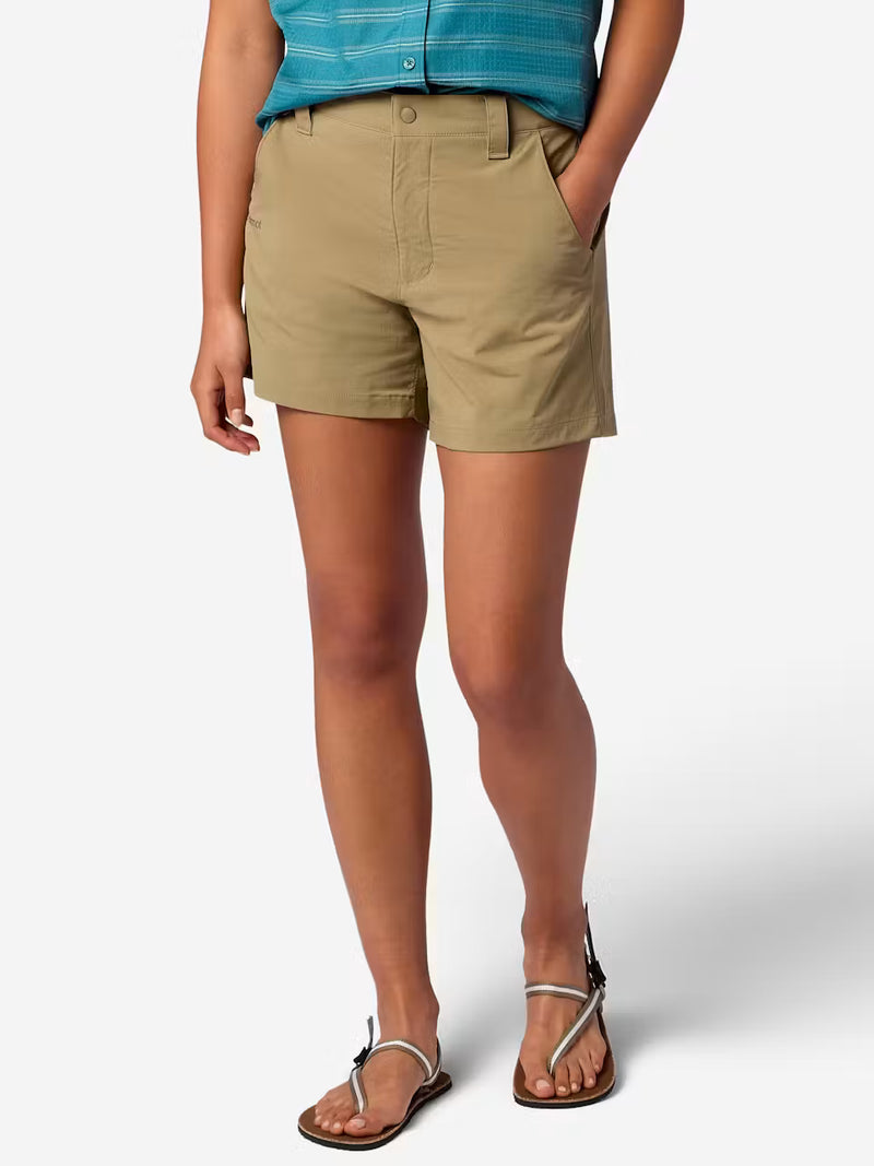 A person wearing tan cargo shorts with hand in their pocket on a white background