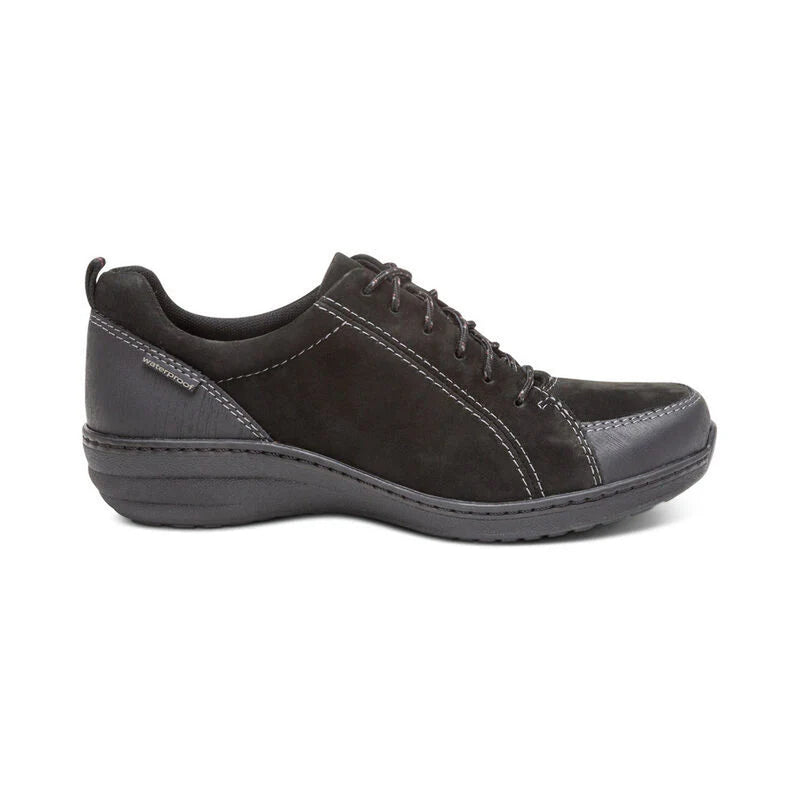 Side view of a black hiking sneaker against a white background. 